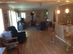 Twin Lakes Idaho Cabin Remodel Family Room, bar seating, new flooring, wood stove installation